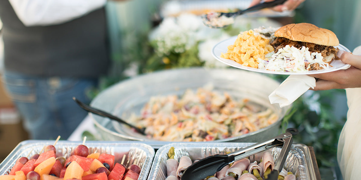 Filling up a plate at an outdoor buffet