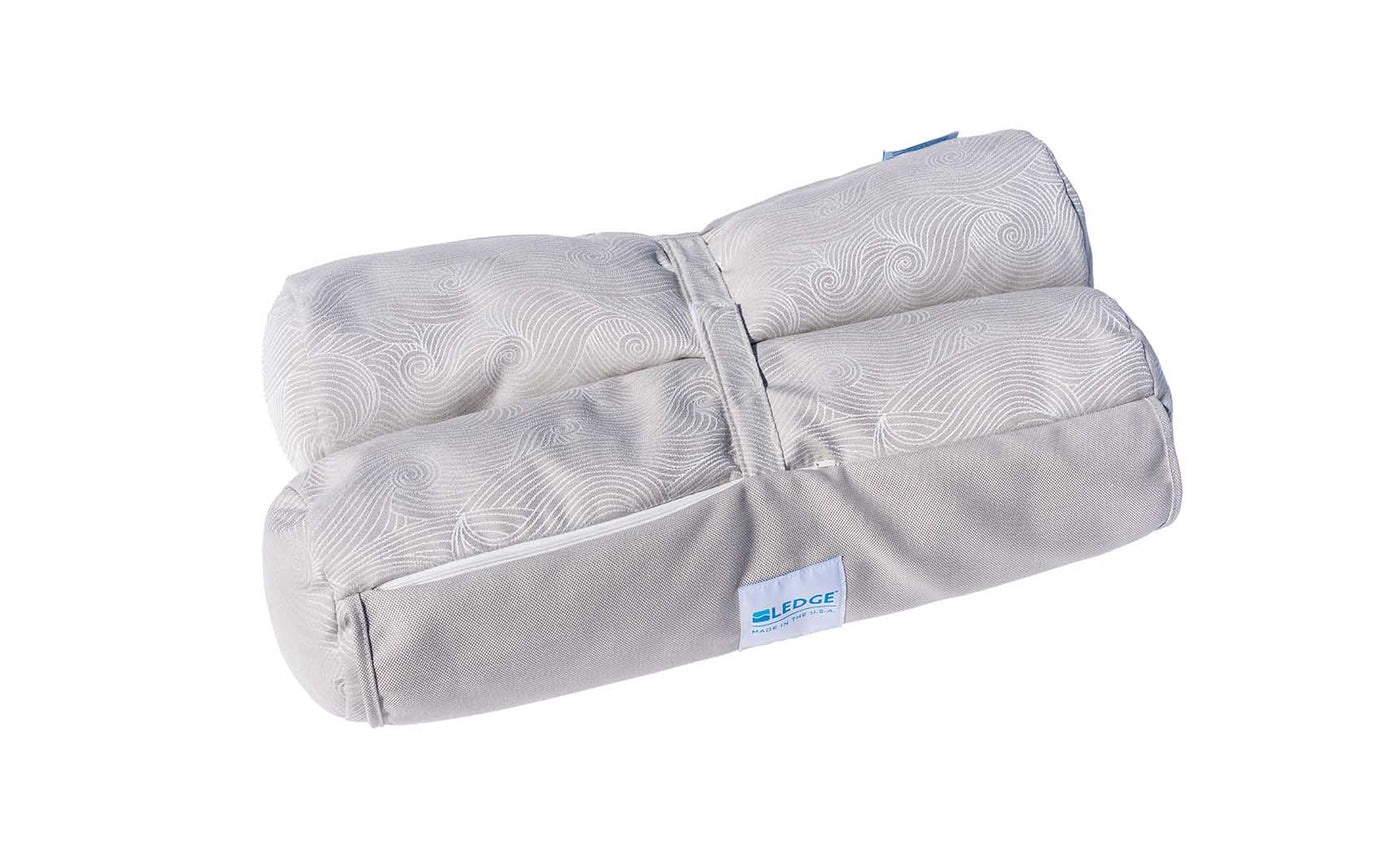 Gray Laze Hammock from Ledge Lounger with a contoured design and subtle swirling pattern similar to marine-grade fabrics. A blue and white BL label is attached on the side, set against a plain white background.