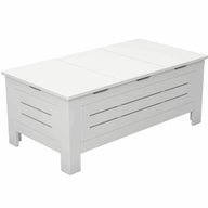 The Mainstay Storage Coffee Table by Ledge Lounger is a white wooden piece with a modern design. It features paneled sides with horizontal slats, ample storage space, and stands gracefully on four short legs, making it a stylish addition to your living room.