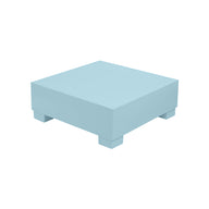 A Signature Coffee Table by Ledge Lounger, cubic in shape and light blue, elegantly rests on four short legs against a plain white background.