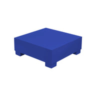 Introducing the Ledge Lounger Signature Coffee Table: a minimalist solid blue square block with four small legs, perfect for poolside essentials and featured on a pristine white background.