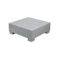 A square gray stone pedestal, similar to the Ledge Lounger Signature Coffee Table, is featured against a white background with four short legs.