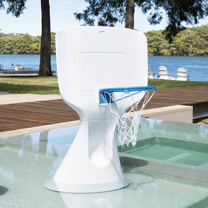 A sleek basketball game on the tanning ledge of a backyard pool.