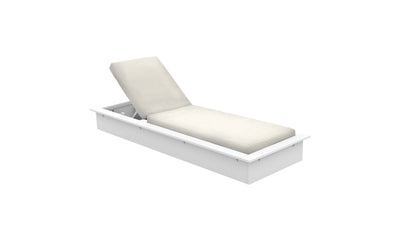 The Echo Chaise by Ledge Lounger is a white adjustable lounger with a cream cushion, ideal for outdoor spaces. Its slightly elevated backrest makes it perfect for relaxing in style against a light backdrop.