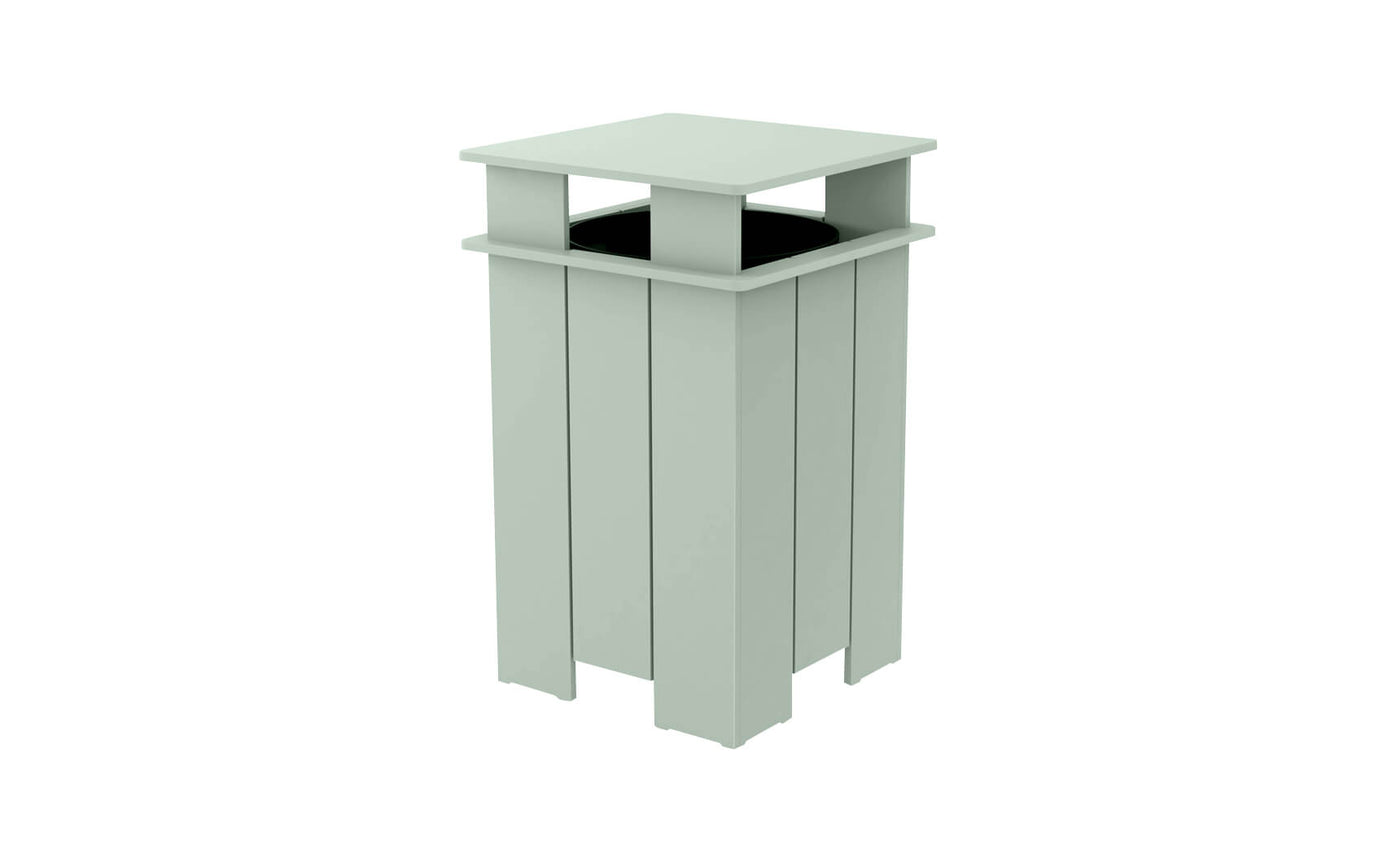 The Ledge Lounger Mainstay Trash Bin is a mint green, square outdoor patio trash can with vertical slats and a flat top. Made from UV stable materials, its open-top design features a covered structure, ideal for public spaces.