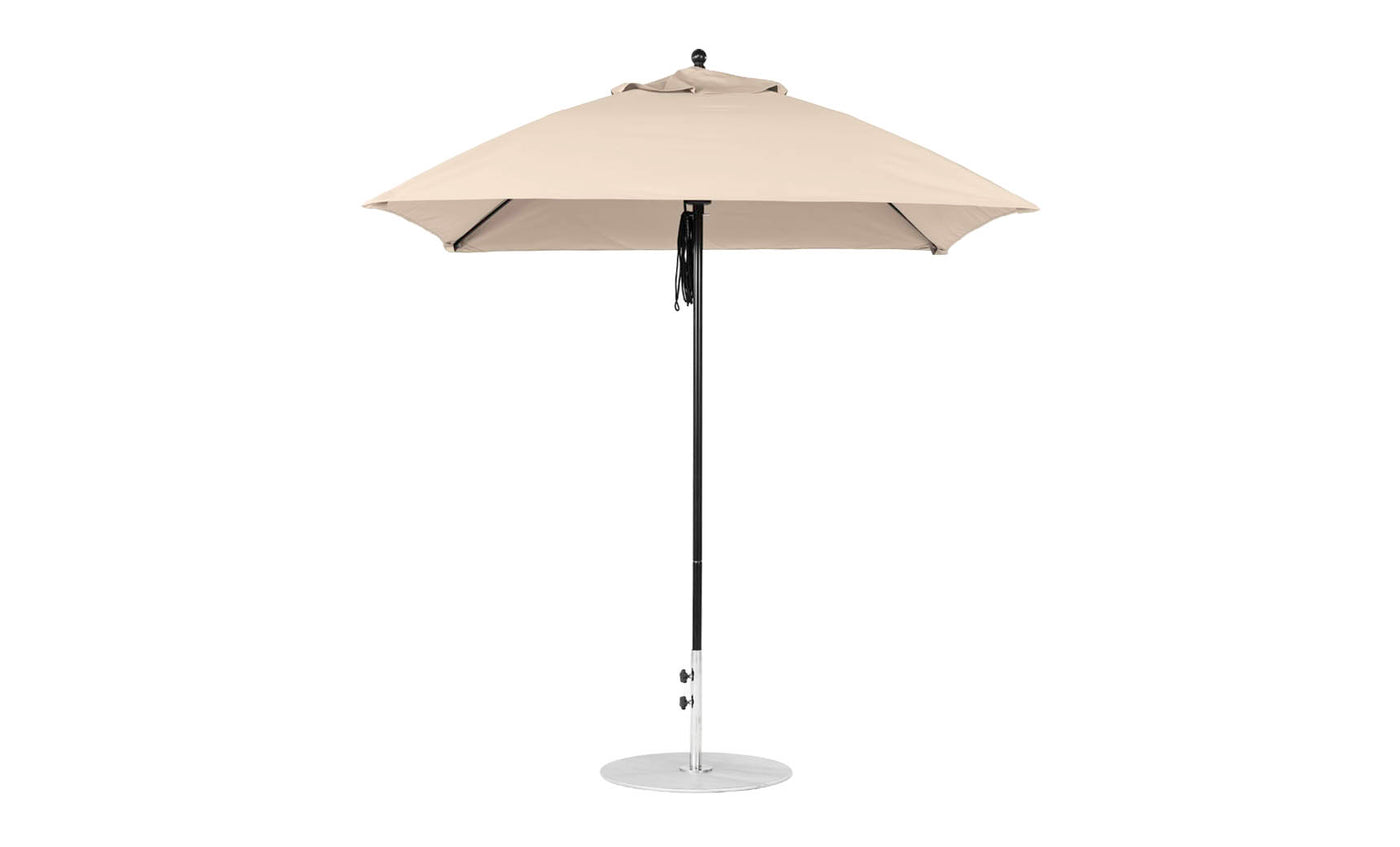 The Ledge Lounger Essential Fiberglass Umbrella, a 7.5 square pulley model in beige, features marine-grade fabrics on a silver pole with a circular base. Its robust design ensures durability and elegance, seen fully open against a plain white background.