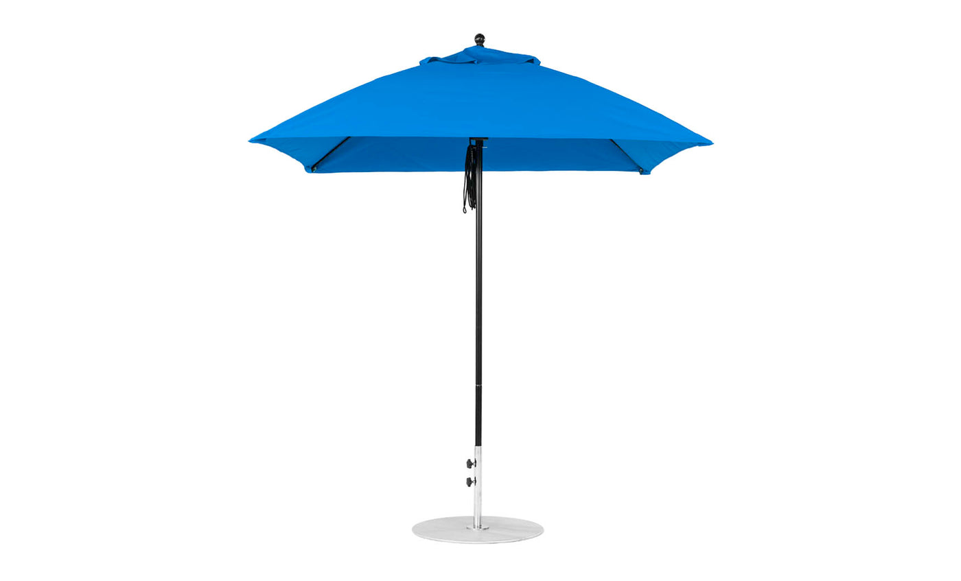 The Essential Fiberglass Umbrella by Ledge Lounger features a 7.5 square design with marine-grade fabric on a pointed top. Its sturdy metal pole rests on a round silver base, combining stylish durability for elegant outdoor shade.