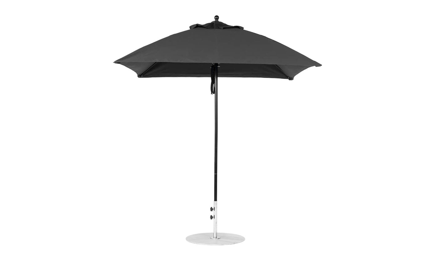 The Ledge Lounger Essential Fiberglass Umbrella features a 7.5 square canopy made from marine-grade fabric, with a sleek black design and silver pole, standing on a circular metal base against a pristine white background.
