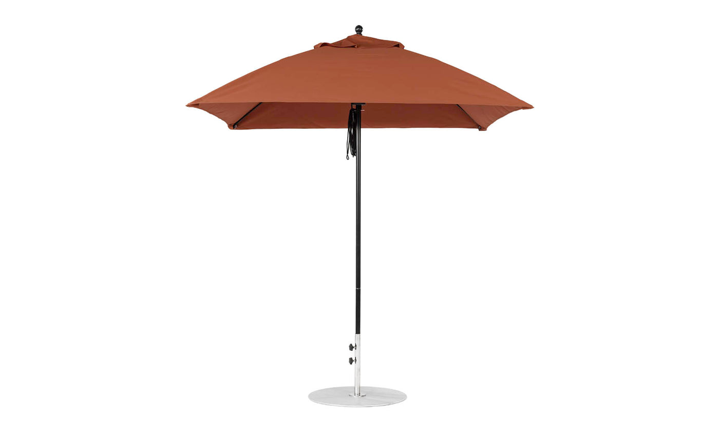 The Essential Fiberglass Umbrella by Ledge Lounger features a tall brown design with a metal pole and round base, showcasing its smooth marine-grade fabric for durability and style in any outdoor setting.