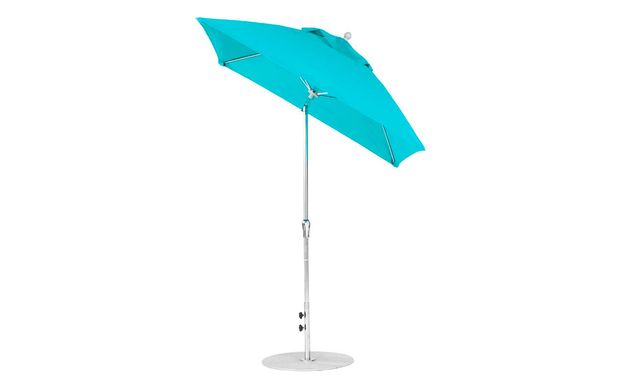The Ledge Lounger Essential Fiberglass Umbrella - 6.5 Square Crank Auto Tilt features marine-grade fabrics in turquoise with a silver pole and round base. Its open, displaying its square sections and tilted for optimal shade.