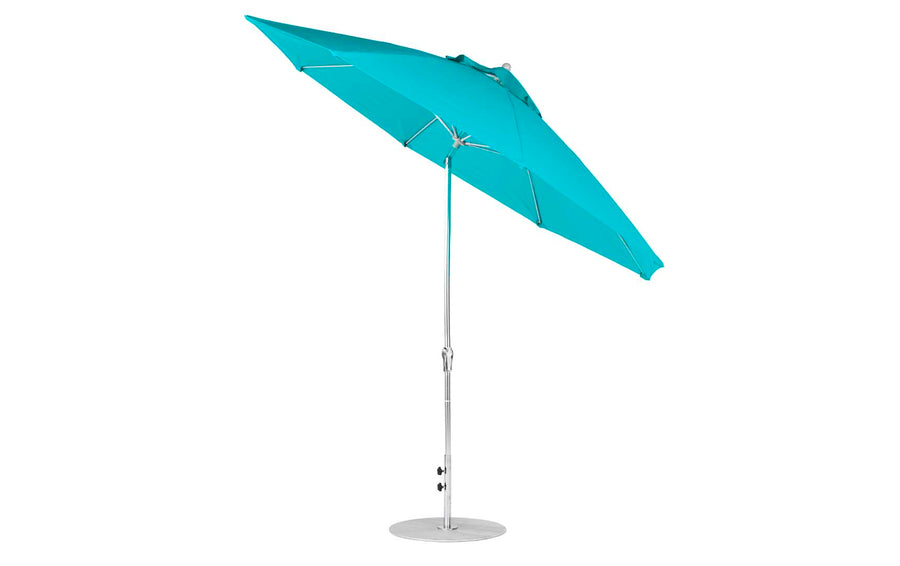 The Ledge Lounger Essential Fiberglass Umbrella has an 11 octagon turquoise canopy made from marine-grade fabrics. It features an aluminum center pole with a circular base, a slight tilt, and a crank handle for easy angle adjustment.