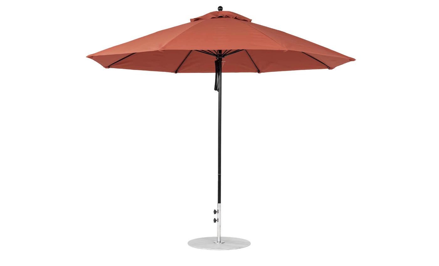 The Essential Fiberglass Umbrella - 11 Octagon Pulley by Ledge Lounger is a large, rust-colored patio umbrella with a sleek black pole and round metal base, made from marine-grade fabrics and fully open for side viewing.