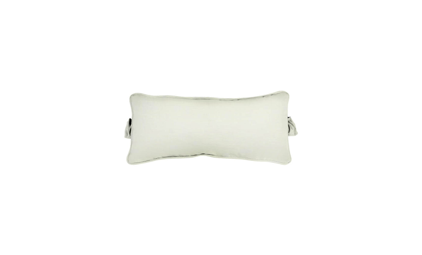 The Signature Headrest Pillow by Ledge Lounger, a rectangular pillow with slightly curved edges in a light color, rests on a white background. It features a small handle and casts a faint shadow, hinting at customizable options for relaxation in the pool.