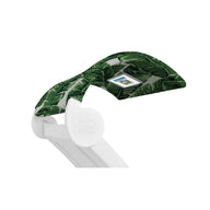The Ledge Lounger Signature Chaise Shade is a white pool lounge chair with a green leaf-patterned canopy and media viewing window for devices, ensuring ergonomic comfort while you relax.