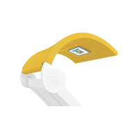 The Signature Chaise Shade by Ledge Lounger is a sleek, minimalist white and yellow desk lamp with an angular design. It features a curved top and an integrated digital media viewing window on the underside to display numbers.