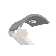 The Signature Chaise Shade by Ledge Lounger is a curved, textured gray lounge with a small media viewing window at its center. Its white base prominently features the Ledge Lounger logo.