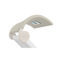 The Signature Chaise Shade by Ledge Lounger is a beige, curved desk light with a flexible neck and integrated LED display for custom positioning. Its rounded base is branded Ledge Lounger, adding style and functionality to any relaxation or work space.