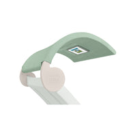 The Signature Chaise Shade by Ledge Lounger has a light green canopy with a digital display and media window. It features a white, smoothly curved base and an engraved brand name, offering a sleek, minimalist design ideal for modern spaces.