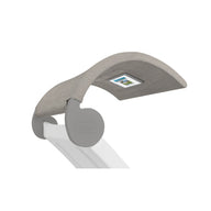 A close-up of the modern minimalist Signature Chaise Shade baby bouncer by Ledge Lounger features a light gray fabric seat, angled on a white frame with circular gray connectors and a small rectangular label, combining style and practicality.