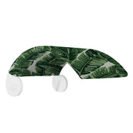 A shelf sporting a banana leaf pattern with curved white brackets is designed to bring tropical flair to your space, akin to an in-pool tanning ledge or shade from the Signature Chair by Ledge Lounger. Its surface showcases a vibrant green leaf design.