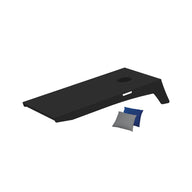The portable Ledge Lounger Cornhole set features a sleek black wooden board with an angled design and circular hole, along with blue and gray bean bags ready for play.