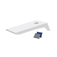 The Ledge Lounger Cornhole Set includes a portable white tabletop board with a hole near the top right corner and comes with a blue and a gray beanbag.
