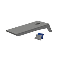 The Ledge Lounger Cornhole, a portable set featuring a gray board with a round hole, comes with two small beanbags—one blue and one gray—ready for play.