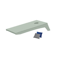 The Ledge Lounger Cornhole board, in green with a circular hole, rests on a white background. This portable set includes one blue and one gray bean bag, ideal for an impromptu game on the go.