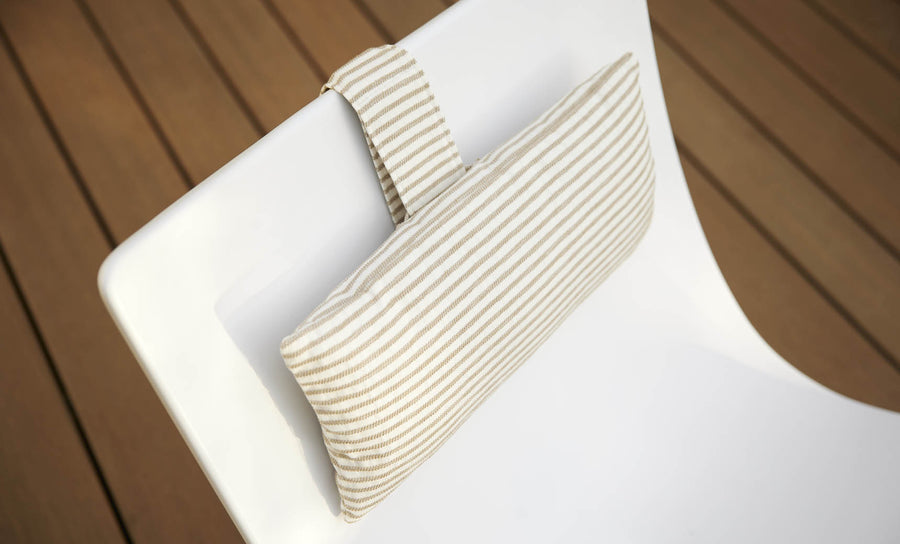 The Autograph Headrest Pillow from Ledge Lounger is a final sale item featuring a white cushion with beige and white stripes, designed to attach securely to a chair backrest via a loop.