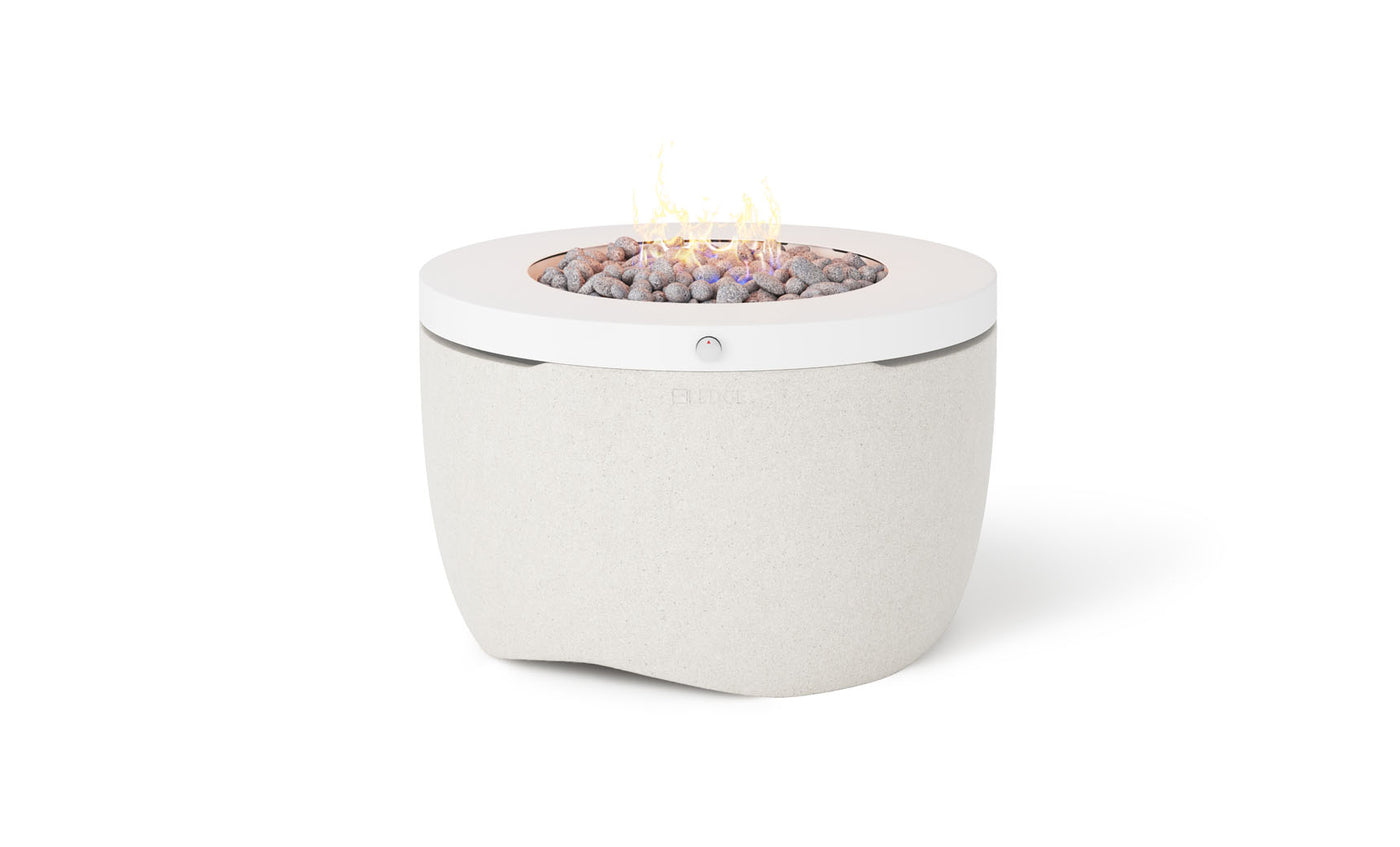 The Halo Firepit by Ledge Lounger is a modern, white propane fire pit with a sleek, minimalist design and a smooth concrete-like surface. Its top boasts arranged stones with a central flame, enhancing any outdoor ambiance effortlessly.