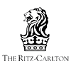 The logo for The Ritz-Carlton features a stylized lion with a crown above it, in black and white. Below the image is the text The Ritz-Carlton.