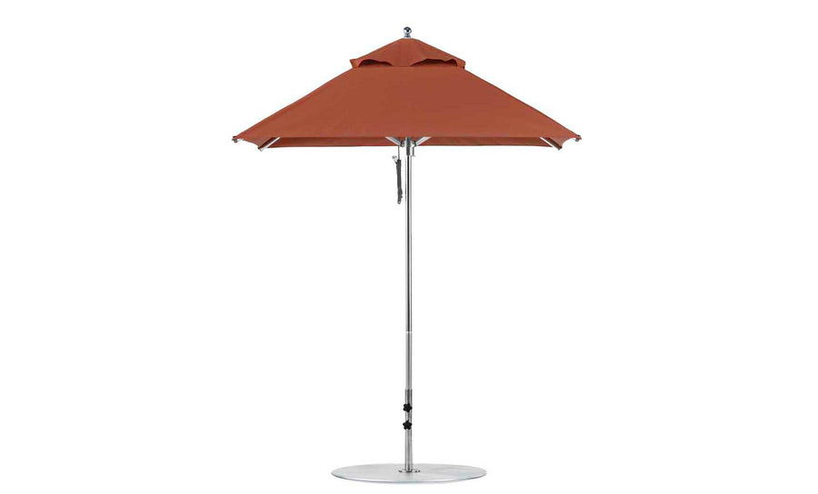 The Premier Aluminum Umbrella by Ledge Lounger features a durable frame and round base, crafted from marine-grade fabric for wind-resistance and shade. This red 6.5 square patio umbrella has a small top vent and stands isolated against a white background.