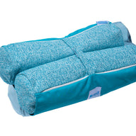 The Laze Hammock by Ledge Lounger is shown in turquoise with marine-grade fabrics. It has a textured finish, zippered pocket, and soft handle for easy carrying. Its compact design highlights functionality as it seamlessly blends into outdoor adventures while being neatly folded.