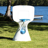 A modern Hoopstr basketball hoop by Ledge Lounger, featuring a blue rim and net, stands on a grassy lawn by the lake. Ideal for a backyard game, trees and a dock accentuate the scene under the clear blue sky.
