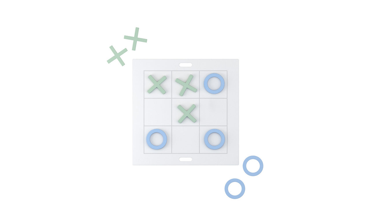A giant Tic Tac Toe board by Ledge Lounger features green Xs and blue Os, with a winning diagonal of Xs from top left to bottom right. Nearby, two loose blue Os and one green X await the next round of this classic lawn game.