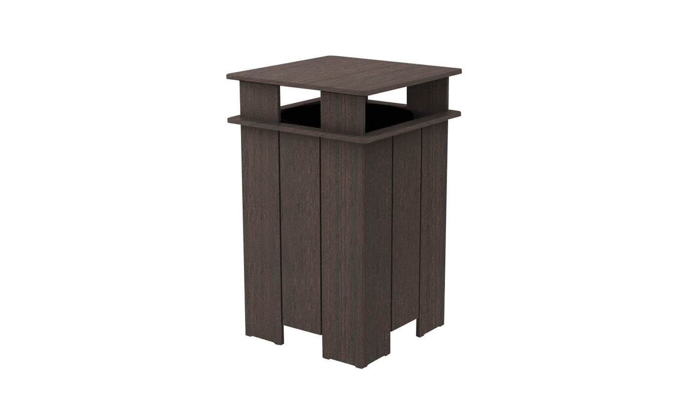 The Mainstay Trash Bin by Ledge Lounger is a tall, dark brown patio can with a square open top. It features vertical slats and a protective overhang, crafted from UV stable materials for durability in outdoor conditions.