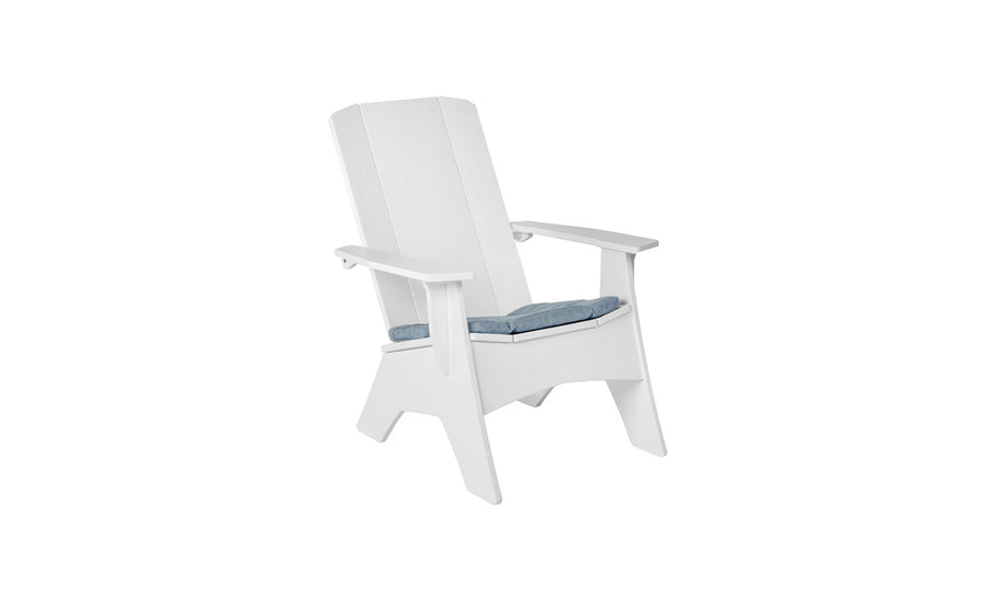 A white wooden Adirondack chair features wide armrests and a slightly reclined backrest. It includes a Mainstay Adirondack Seat Cushion by Ledge Lounger in blue, making it an ideal outdoor seat. The setup sits against a plain white background.