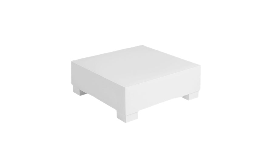 The Ledge Lounger Signature Sectional Endcap is a minimalist, cube-shaped platform with short legs against a plain white background. Its clean corners highlight modern simplicity, making it perfect for display.