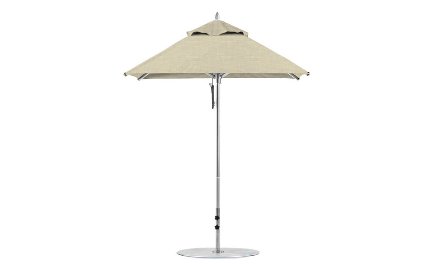 A Ledge Lounger Premier Aluminum Umbrella in beige features a round canopy with a silver pole on a circular base, available as a 6.5 square pulley model in the final sale.