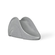 The Ledge Lounger Signature Slide is a modern, minimalist piece with a smooth, curvy design. Its compact gray structure on a neutral white background highlights its sleek and simple aesthetic.