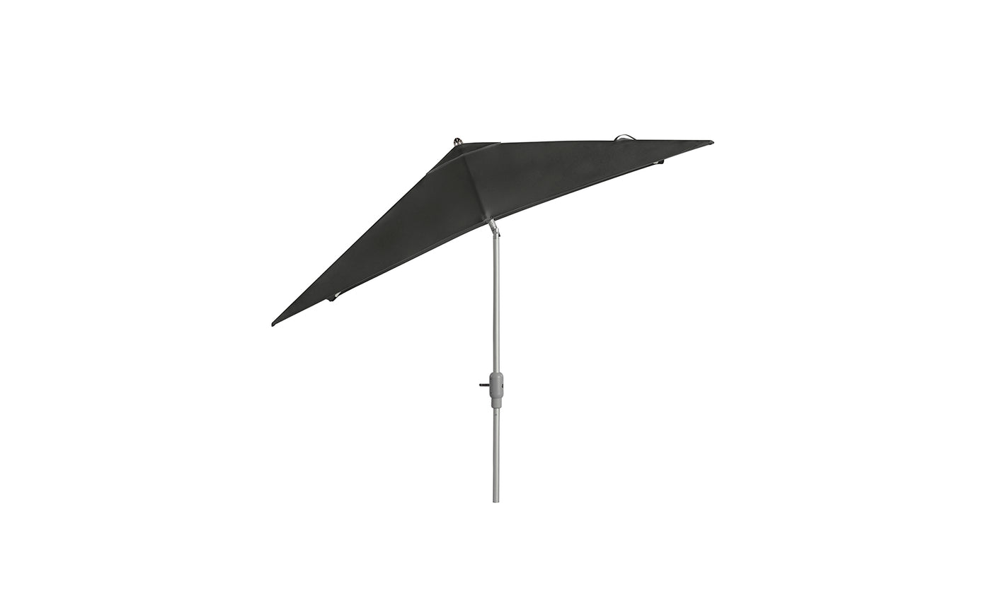The Ledge Lounger 8.5 Square Signature 360° Tilt Umbrella, with a sleek silver pole in a dark green triangular design, epitomizes resort-level elegance as it stands against a white background.