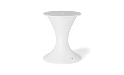 A sleek white side table with a narrow middle forms an hourglass shape and doubles as an outdoor table. Its smooth surface has a small blue Ledge Lounger logo near the base, ideal next to your Autograph Umbrella Stand Ice Bin. The background is plain white.