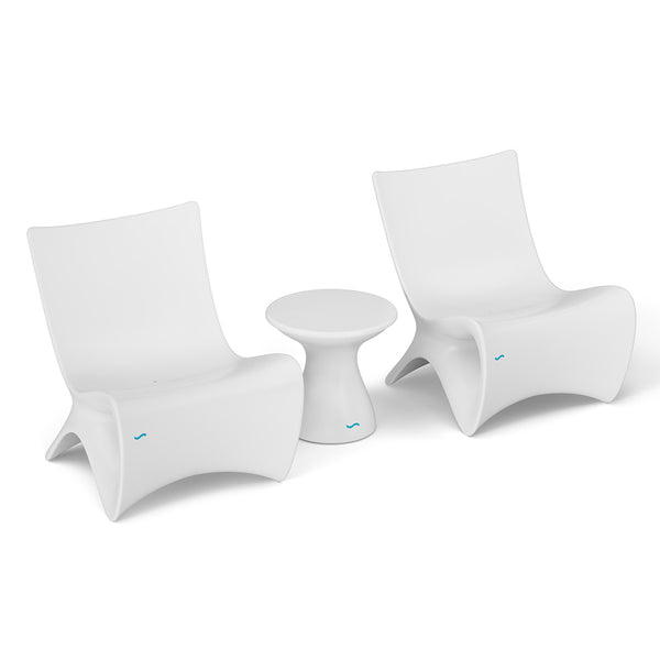 Two Classic Luxury In-Pool Chair Duo from Ledge Lounger, featuring sleek curved designs in modern white, stand beside a petite round side table. Set against a plain white backdrop, this arrangement creates a minimalist and contemporary atmosphere.