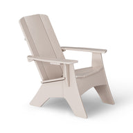 The Mainstay Ultimate Adirondack by Ledge Lounger, in beige, is the ideal outdoor lounge furniture. With wide armrests and a slanted backrest, it promises stylish poolside relaxation. Viewed from the side against a white backdrop, it offers both comfort and elegance.