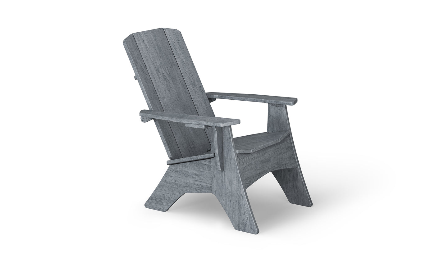The Mainstay Ultimate Adirondack by Ledge Lounger, shown from the side against a white background, is an ideal outdoor lounge chair with a grey wooden finish, featuring a slanted backrest and wide armrests.