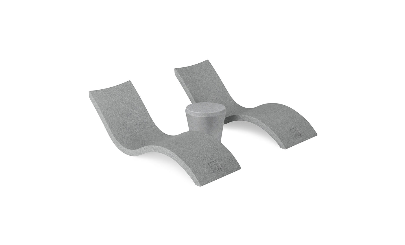 The Ledge Lounger Signature Chaise and Affinity Side Table In-Pool Set features two modern gray wave-shaped loungers with a side table between them, displayed on a white background.