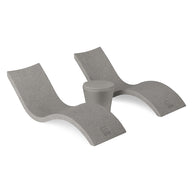 The Ledge Lounger Signature Chaise and Affinity Side Table In-Pool Set features two sleek gray curved loungers paired with a stylish side table, all displayed against a plain white background.