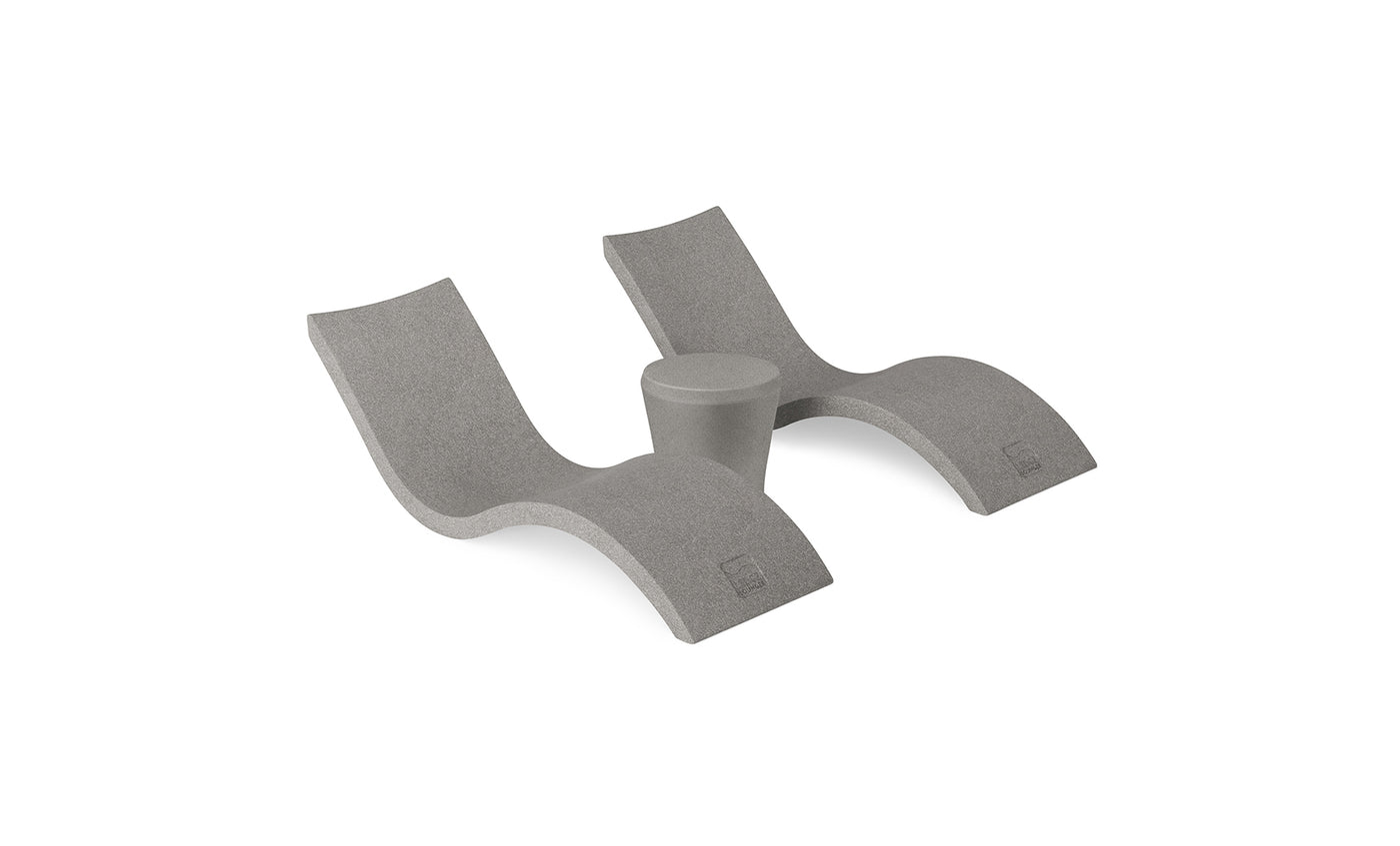 The Ledge Lounger Signature Chaise and Affinity Side Table In-Pool Set features two sleek gray curved loungers paired with a stylish side table, all displayed against a plain white background.