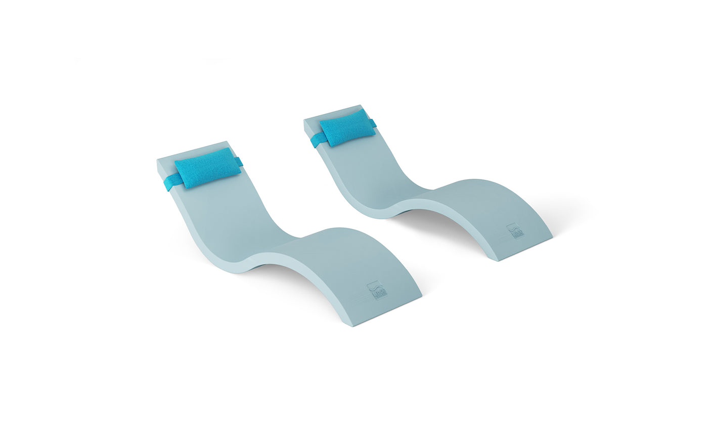 The Outdoor Escape In-Pool Furniture Bundle by Ledge Lounger includes two light blue, wave-shaped foam chaise lounges with headrest pillows, ideal for outdoor pool settings. Their sleek, contoured design is perfect for floating on water and is showcased against a pristine white background.