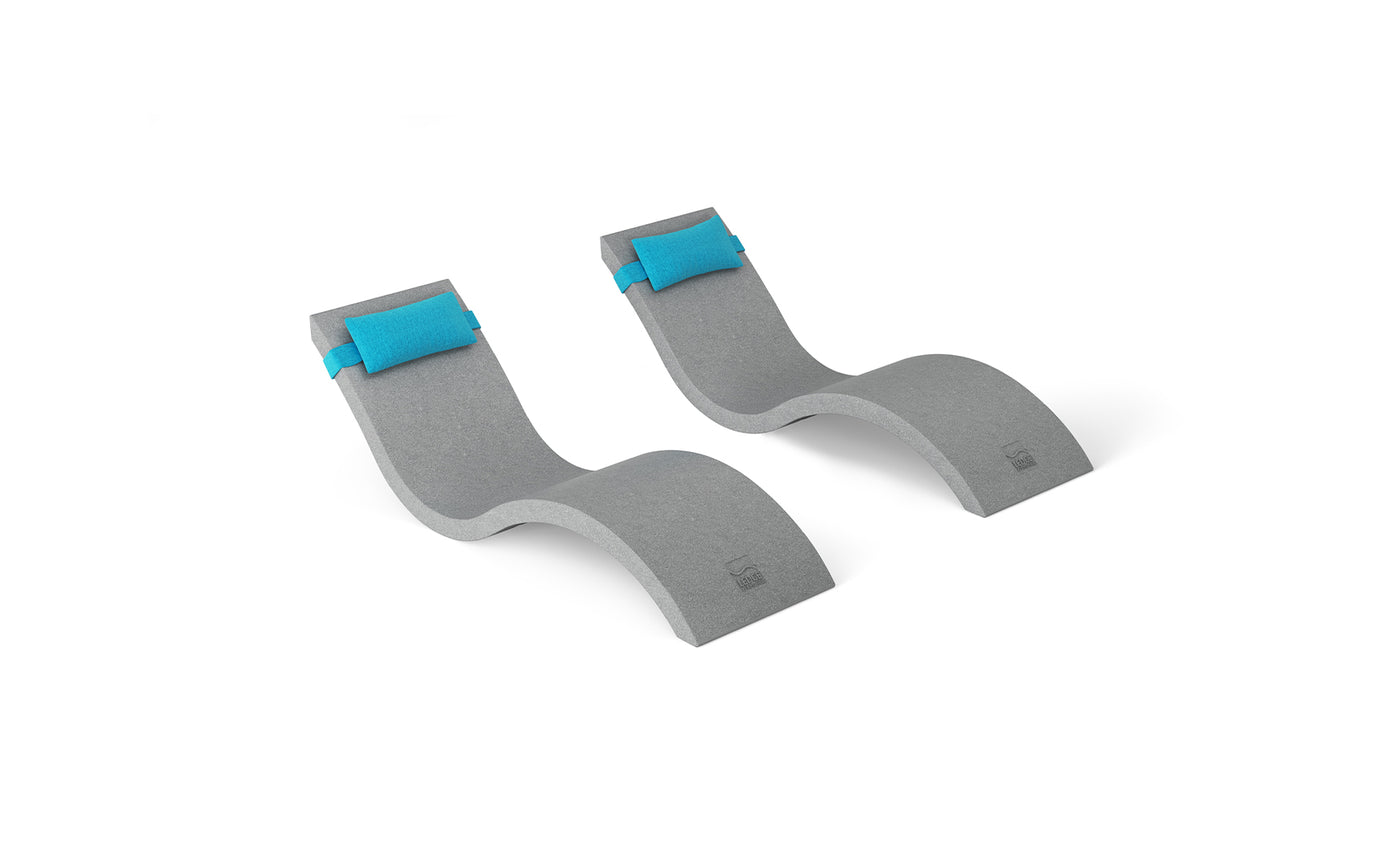 The two gray, curved foam back stretchers on a white background from the Ledge Lounger Outdoor Escape In-Pool Furniture Bundle resemble mini chaise lounges. They each feature a blue cushioned area at the top for ultimate comfort akin to a headrest pillow.